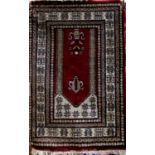 Persian full pile rug with central still life medallion upon a deep red ground, 140 x 80cm (af)