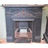 A reclaimed cast iron fire insert, with raised floral and further detail, 107cm wide