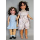 2 early 20th century large composition head dolls, both with closing blue eyes, the taller doll 75cm