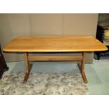 An Ercol light elm refectory style occasional table, the rectangular top with moulded outline and