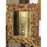 Plaster moulded frame with gilded finish enclosing a bevelled edged mirror plate, 55 x 50cm approx