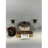 A collection of tortoiseshell dressing set items to include two large cut glass scent bottles, heart