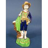 A 19th century Staffordshire type figure of a man in Tyrolean style costume, 25cm tall approx