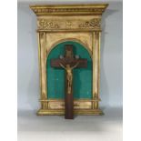 Cast metal applied crucifix set to a giltwood gesso backboard 66cm high, together with a further