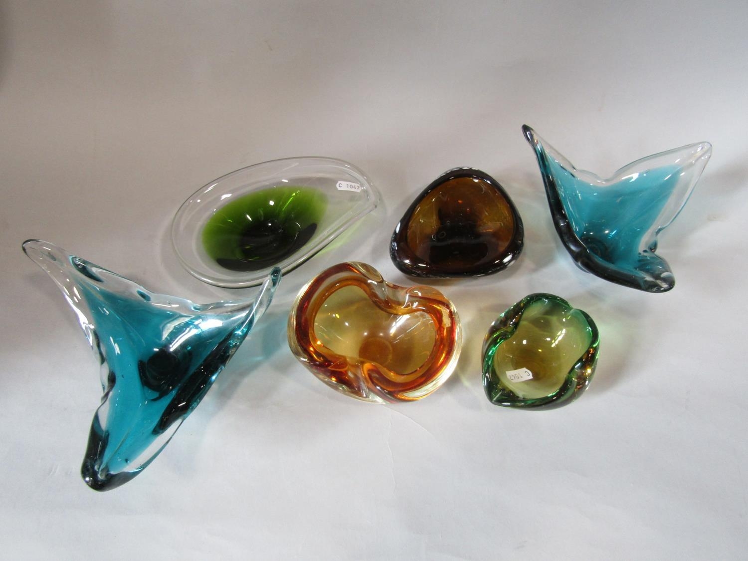 Six Murano glass dishes of varying shape form and colourway