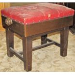 A vintage piano stool with rising frame and maroon buttoned upholstery