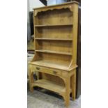 A narrow reclaimed stripped pine cottage kitchen dresser, the raised open plate rack with three