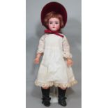 Bisque head doll by Armand Marseille with closing blue eyes, open mouth with teeth and jointed