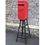 A reclaimed cast iron and alloy post box with traditional red livery raised lettering Post Office ER
