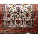 A good Tabriz carpet with various scrolled foliate decoration upon a pale ground, 335 x 205cm