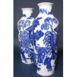 A pair of oriental vases with blue and white painted decoration of figures in a landscape setting