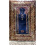 Kashmir type rug with delicate floral decoration and cobalt blue inset panel upon a cream ground,