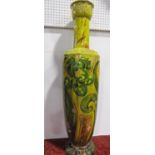 A large late 19th century Bretby floorstanding vase with drawn neck and with boldly painted green