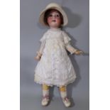 Large German bisque head doll circa 1920's with closing blue eyes, open mouth with teeth and jointed