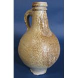 A continental Bellarmine type stoneware bottle with typical mask detail and crest, 21.5 cm tall