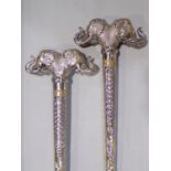 Unusual pair of Indian white metal novelty walking sticks, each with large twin elephant head knops