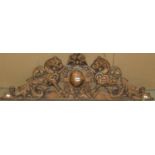 A Victorian carved oak panel showing lions around a central cartouche, 150cm long x 37cm high