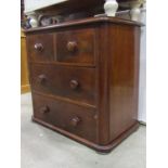 A small Victorian mahogany bedroom chest of two long and two short oak lined drawers, flanked by