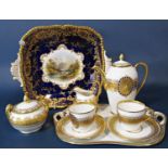 A continental coffee set for two with blue and gilt decoration on a white ground