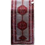 Good quality Persian Serab runner with red floral medallions and floral running fields upon a