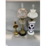 Brass Corinthian column oil lamp with glass reservoir, further opaline oil lamp and a further