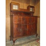 An early 20th century mahogany freestanding dentist cabinet enclosed and fitted with an