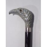 Ebonised walking cane, with carved and laquered eagle head knop