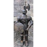 A novel hall/fireside ornament in the form of a standing knight wearing a full suit of armour