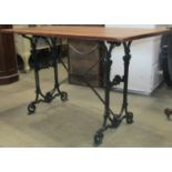 A Victorian cast iron table with pierced decoration, set beneath a later timber top, 120cm, long