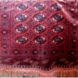 Antique Turkamen Bokhara rug with typical geometric decoration upon a washed red ground, 180 x 110cm