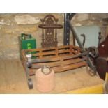 Iron work bow fronted fire basket with c-scrolled supports, a stone weight / tether with ring