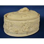 An early 19th century Wedgwood caneware game dish and cover with relief moulded fruiting vine and