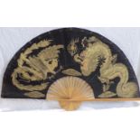 An unusual large ornamental fan, probably Chinese, with black fabric leaf decorated with a gold