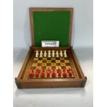 Antique travelling games board together with a vintage chess set and dominos set (3)