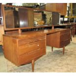 A mid 20th century teak long and low kneehole dressing table with raised rectangular mirror over six