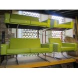 A retro style light green faux leather upholstered three piece suite comprising a two seat sofa