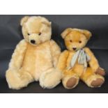 2 large teddy bears, both with jointed body, golden fur, glass eyes and stitched nose and mouth.
