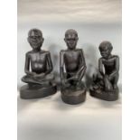 Tribal interest - three carved wooden figures of seated tribesman signed S.Wmalula, largest 32cm