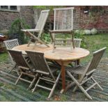 A weathered hardwood D end and extending garden table, the slatted panelled top with two