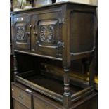 Old English oak cupboard enclosed by two panelled doors on turned supports, 91cm wide