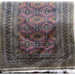 Turkamen Bokhara rug with typical geometric decoration, with black outline upon a pale ground, 180 x