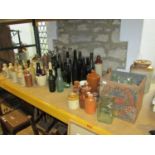 A large local collection of vintage stoneware ginger beer,codd and other glass bottles to include