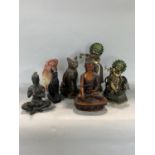 A collection of far eastern figures to include three cast metal deities, a soapstone sage, two