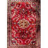 Unusual Persian Lilihan rug with decorative floral decoration upon a deep red ground, 150 x 100cm