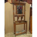 An Edwardian Art Nouveau/Craft style oak hallstand of full height, the back incorporating a