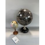 Modern ebonised terrestrial globe together with a further smaller coloured example by authentic