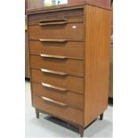 A mid 20th century teak bedroom chest of seven long drawers with moulded detail, the upper with