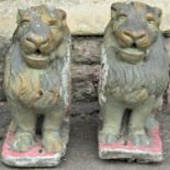 A pair of reclaimed pier caps or garden ornaments in the form of seated lions/dogs of fo, with