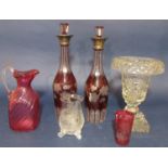 Pair of cranberry glass decanters with faceted necks etched with berry leaf decoration together with