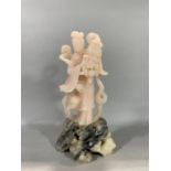 Chinese rose stone carving of a standing Guanyin, 28cm high